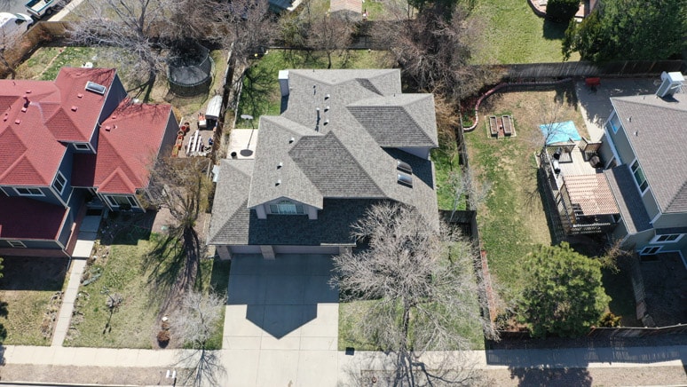 Aerial photo of a house in Aurora, Colorado with a gray asphalt shingle roof in the center of the image