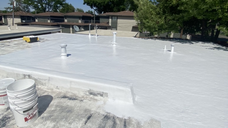 Silicone flat roof coating by Metro City Roofing in Denver, CO